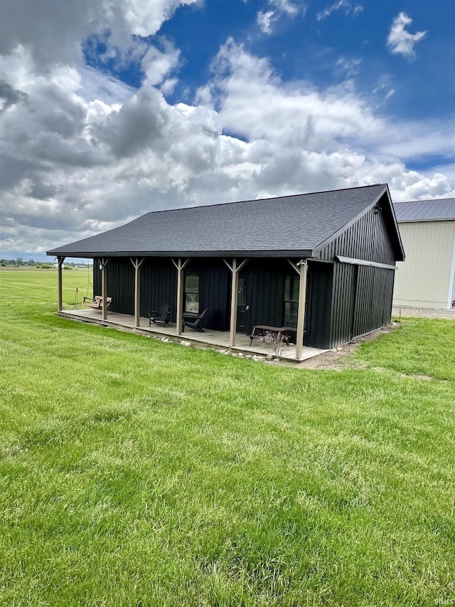 65600 Ash Rd, Wakarusa, IN 46573 - rear view of property with a yard, a patio area, roof with shingles, and board and batten siding
