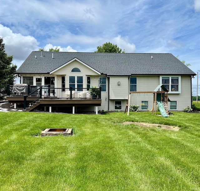 65600 Ash Rd, Wakarusa, IN 46573 - back of house featuring a wooden deck, a fire pit, a lawn, and a shingled roof