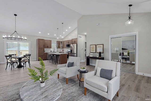 51650 Prescott Ave, South Bend, IN 46637 - living area featuring light wood-style floors, a chandelier, high vaulted ceiling, baseboards, and recessed lighting