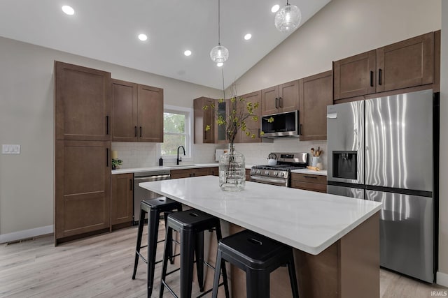51650 Prescott Ave, South Bend, IN 46637 - kitchen with appliances with stainless steel finishes, a sink, light wood-style floors, recessed lighting, and tasteful backsplash