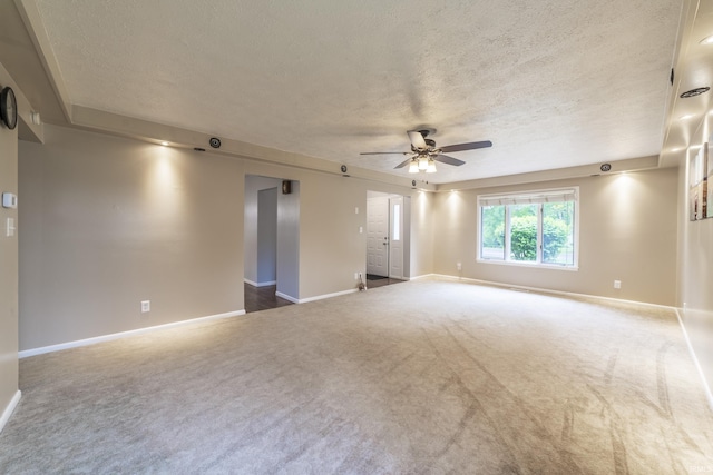 409 N Dorothy St, Monon, IN 47959 - spare room with a textured ceiling, carpet flooring, baseboards, and a ceiling fan