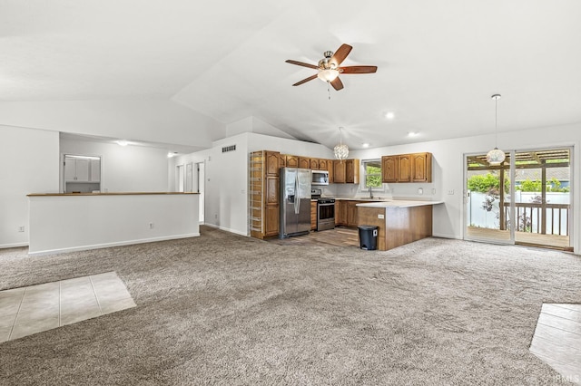 4019 Riverside Dr, South Bend, IN 46628 - kitchen featuring appliances with stainless steel finishes, open floor plan, carpet flooring, light countertops, and brown cabinetry