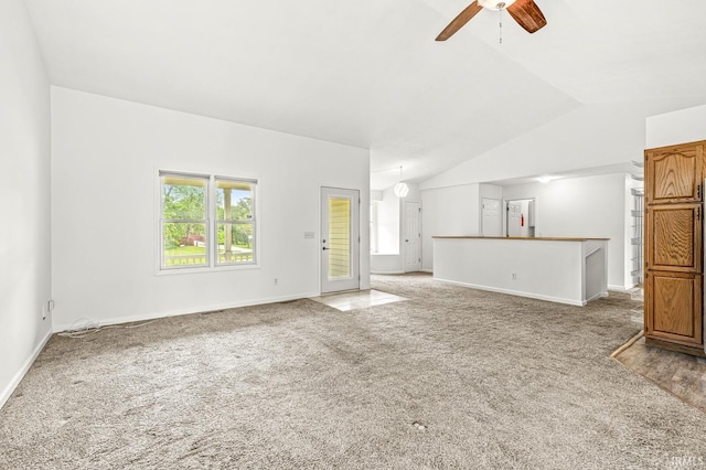 4019 Riverside Dr, South Bend, IN 46628 - unfurnished living room with vaulted ceiling, carpet flooring, ceiling fan, and baseboards