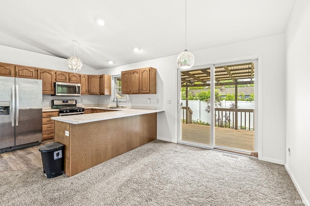 4019 Riverside Dr, South Bend, IN 46628 - kitchen featuring stainless steel appliances, lofted ceiling, light countertops, a sink, and a peninsula