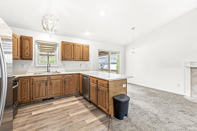 4019 Riverside Dr, South Bend, IN 46628 - kitchen featuring stainless steel appliances, a sink, a peninsula, brown cabinetry, and light countertops