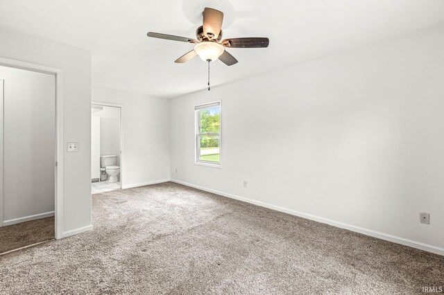 4019 Riverside Dr, South Bend, IN 46628 - unfurnished bedroom with carpet flooring, baseboards, connected bathroom, and a ceiling fan