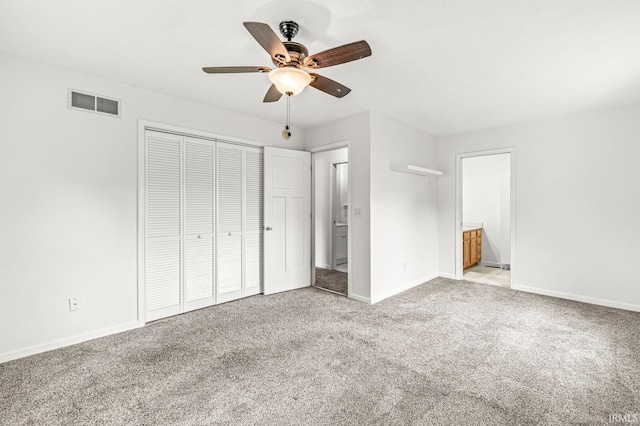 4019 Riverside Dr, South Bend, IN 46628 - unfurnished bedroom featuring carpet flooring, a closet, baseboards, ensuite bathroom, and ceiling fan