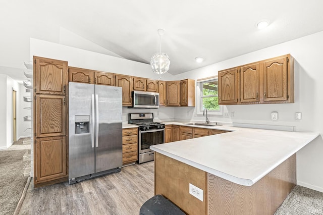 4019 Riverside Dr, South Bend, IN 46628 - kitchen featuring stainless steel appliances, a sink, a peninsula, light countertops, and brown cabinets