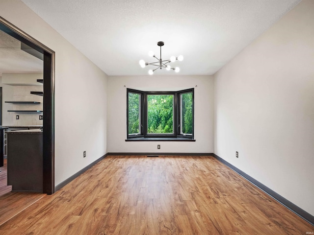 9826 Flag Stone Pl, Fort Wayne, IN 46804 - unfurnished dining area featuring a chandelier, light wood finished floors, and baseboards