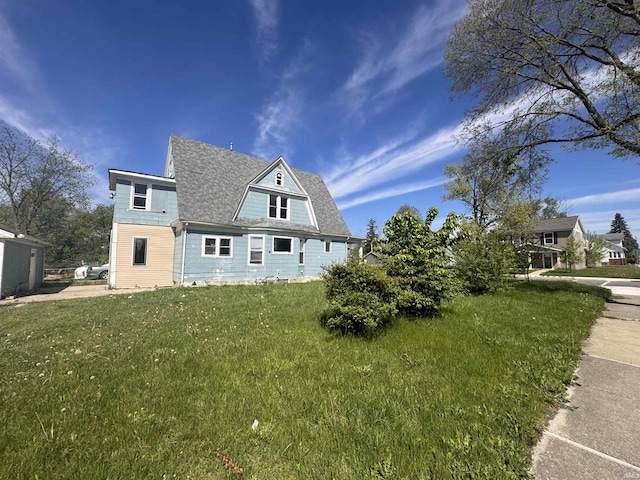 1326 E Pontiac St, Fort Wayne, IN 46806 - view of side of home featuring a yard and a shingled roof