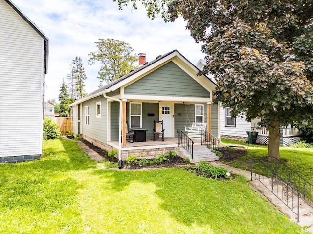 1712 S Elm St, Muncie, IN 47302 - shotgun-style home with covered porch and a chimney