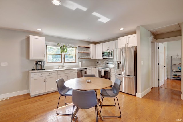 3231 N Kingsley Dr, Bloomington, IN 47404 - kitchen with appliances with stainless steel finishes, white cabinetry, baseboards, light countertops, and recessed lighting