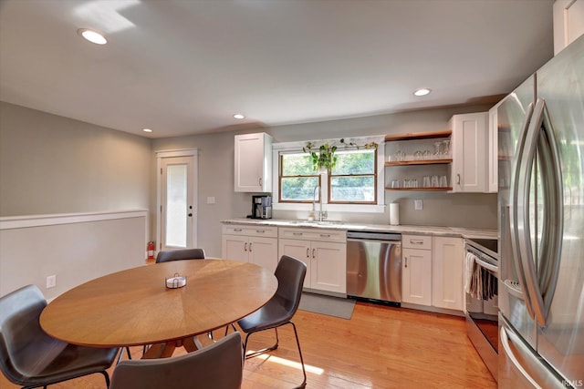 3231 N Kingsley Dr, Bloomington, IN 47404 - kitchen with stainless steel appliances, recessed lighting, white cabinetry, light wood finished floors, and light countertops