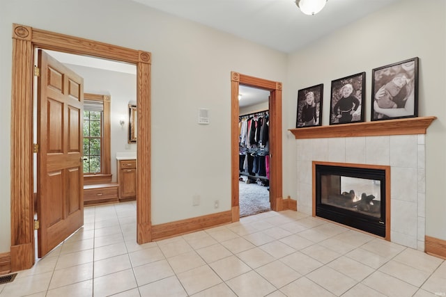 corridor with light tile patterned floors and baseboards