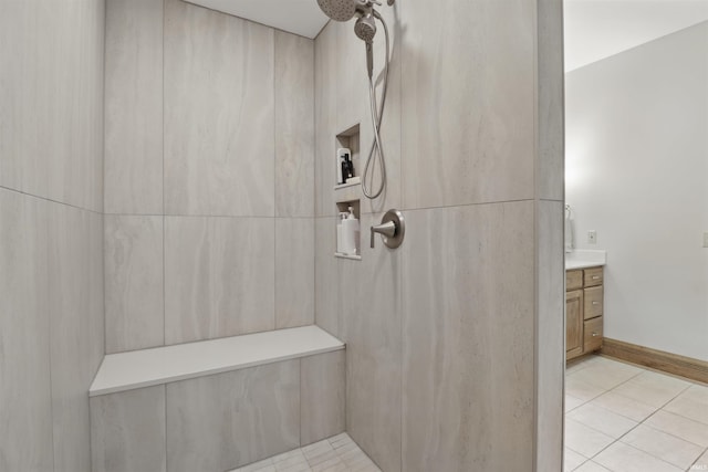 full bath with tiled shower, tile patterned flooring, and vanity