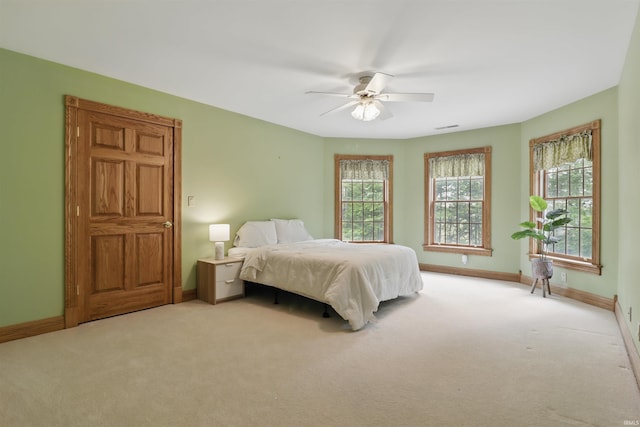 bedroom with carpet floors, baseboards, and ceiling fan