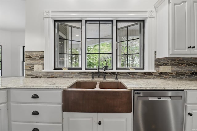 kitchen with dishwasher, a sink, decorative backsplash, white cabinets, and light stone counters
