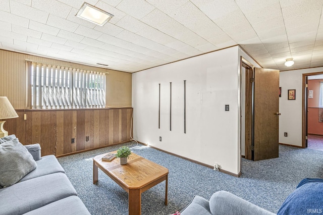 5023 Cedarwood Ln, South Bend, IN 46619 - living area featuring wooden walls, carpet floors, a wainscoted wall, and baseboards