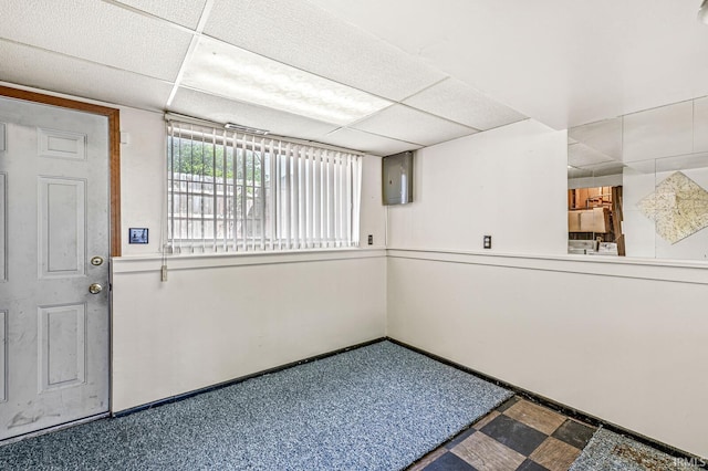 5023 Cedarwood Ln, South Bend, IN 46619 - unfurnished room featuring tile patterned floors, a paneled ceiling, baseboards, and electric panel