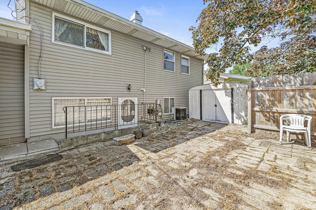 5023 Cedarwood Ln, South Bend, IN 46619 - rear view of property featuring central AC and a chimney