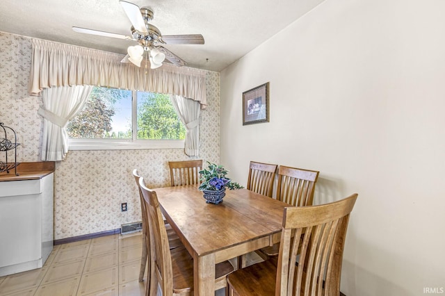 5023 Cedarwood Ln, South Bend, IN 46619 - dining room featuring wallpapered walls, a ceiling fan, a textured ceiling, and light flooring