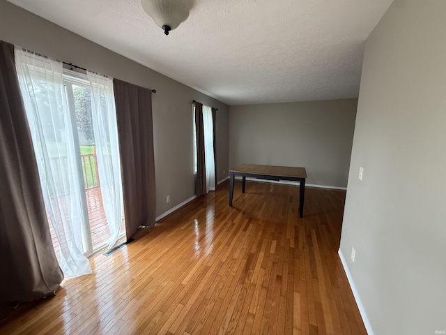 37 Ems D22A Ln, Syracuse, IN 46567 - empty room featuring light wood finished floors, baseboards, and a textured ceiling