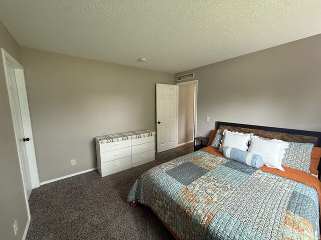 37 Ems D22A Ln, Syracuse, IN 46567 - bedroom with baseboards, dark carpet, and a textured ceiling