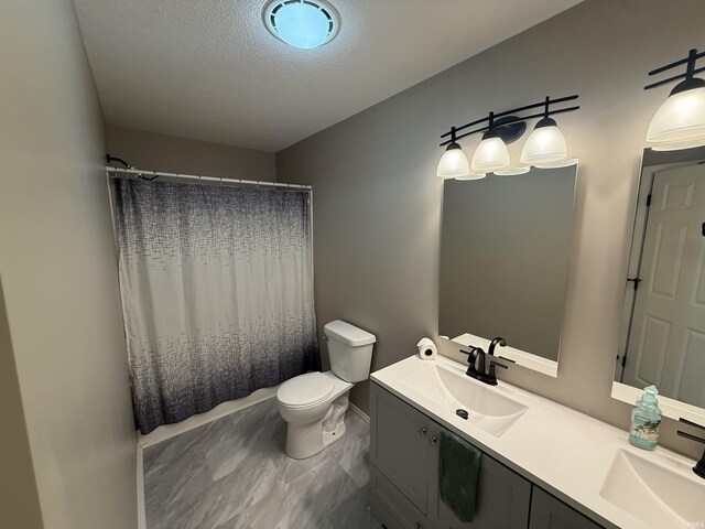 37 Ems D22A Ln, Syracuse, IN 46567 - bathroom with toilet, double vanity, curtained shower, a textured ceiling, and baseboards