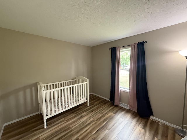 37 Ems D22A Ln, Syracuse, IN 46567 - bedroom with wood finished floors, a textured ceiling, and baseboards