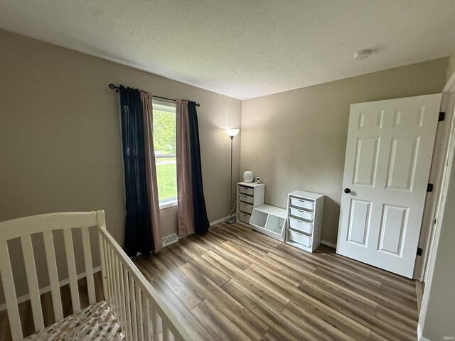 37 Ems D22A Ln, Syracuse, IN 46567 - unfurnished bedroom with wood finished floors, a textured ceiling, and baseboards