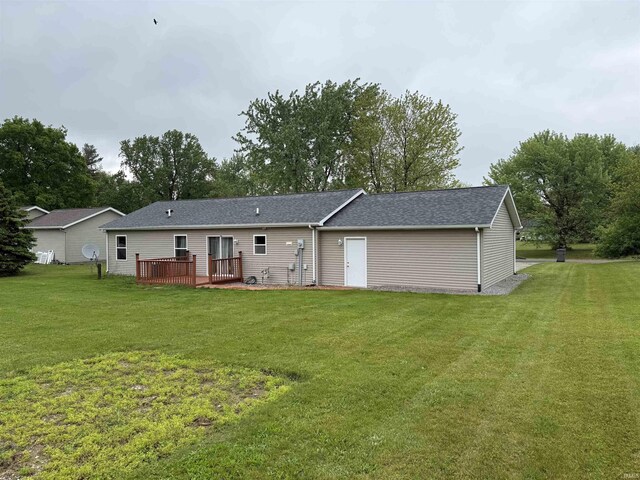 37 Ems D22A Ln, Syracuse, IN 46567 - back of house featuring a wooden deck, a yard, and a shingled roof
