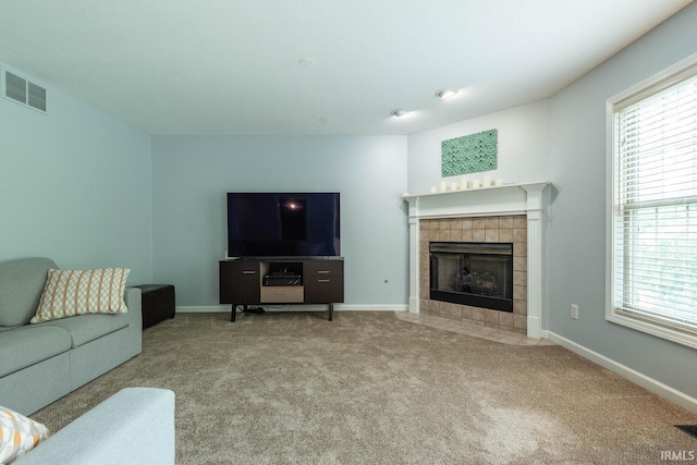 3308 S Daniel Ct, Bloomington, IN 47401 - carpeted living area with a tile fireplace, plenty of natural light, and baseboards