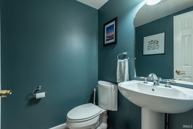 3308 S Daniel Ct, Bloomington, IN 47401 - bathroom featuring toilet, baseboards, and a sink