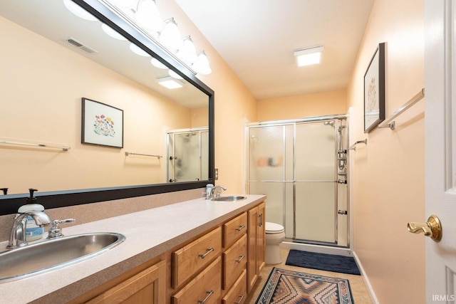 3308 S Daniel Ct, Bloomington, IN 47401 - bathroom with toilet, a shower stall, and double vanity