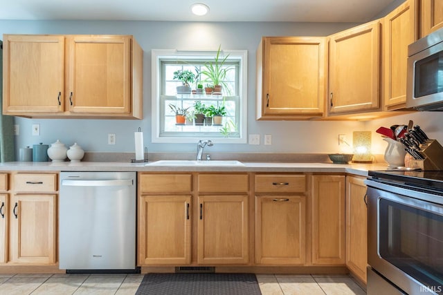 3308 S Daniel Ct, Bloomington, IN 47401 - kitchen featuring stainless steel appliances, a sink, light brown cabinets, light tile patterned floors, and light countertops