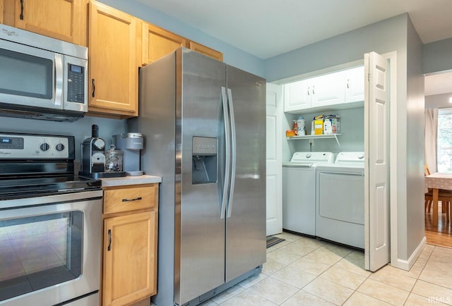3308 S Daniel Ct, Bloomington, IN 47401 - kitchen with appliances with stainless steel finishes, washer and dryer, light tile patterned floors, and light countertops