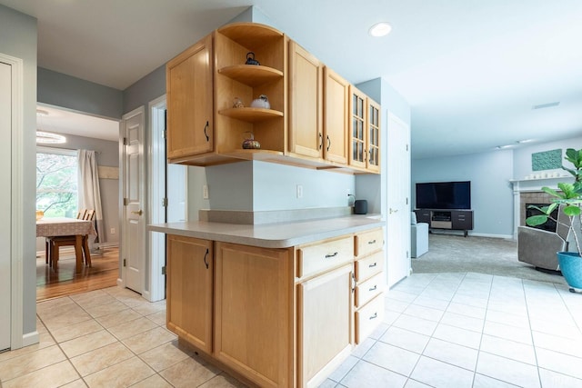 3308 S Daniel Ct, Bloomington, IN 47401 - kitchen with open shelves, light tile patterned flooring, light countertops, glass insert cabinets, and open floor plan