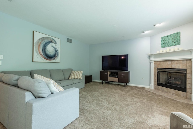 3308 S Daniel Ct, Bloomington, IN 47401 - carpeted living area featuring a tiled fireplace and baseboards