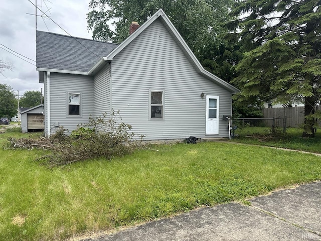 1207 Short Columbia St, Frankfort, IN 46041 - view of side of property featuring roof with shingles and a chimney