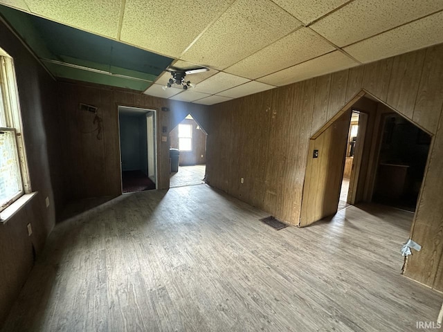 1207 Short Columbia St, Frankfort, IN 46041 - empty room with wooden walls, a paneled ceiling, and wood finished floors