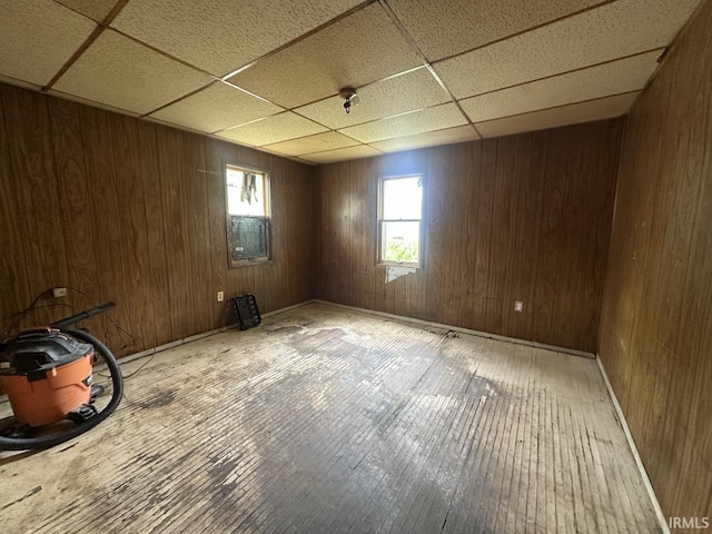 1207 Short Columbia St, Frankfort, IN 46041 - spare room with a paneled ceiling, hardwood / wood-style flooring, wood walls, and baseboards