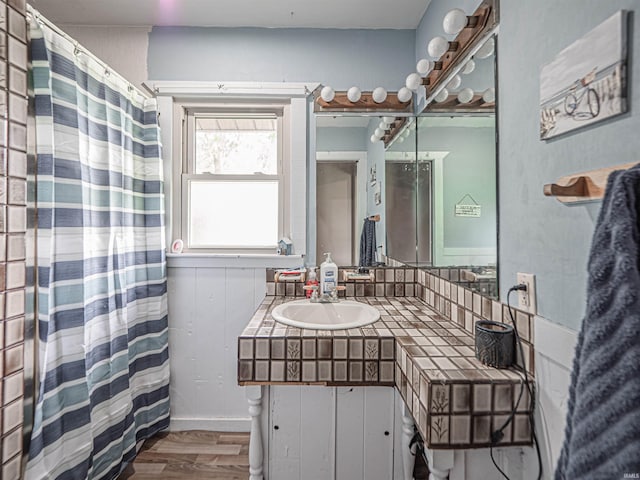210 S E St, Oakland City, IN 47633 - bathroom featuring wood finished floors, vanity, and curtained shower