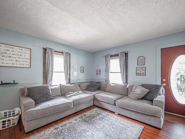 210 S E St, Oakland City, IN 47633 - living area with healthy amount of natural light, a textured ceiling, and wood finished floors