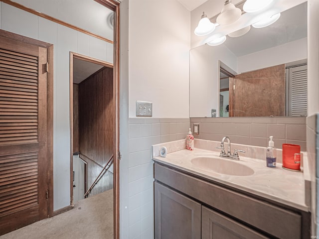 210 S E St, Oakland City, IN 47633 - bathroom featuring vanity, tile walls, and a chandelier