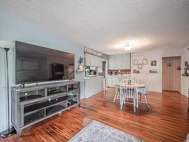 210 S E St, Oakland City, IN 47633 - dining area featuring hardwood / wood-style floors and a textured ceiling