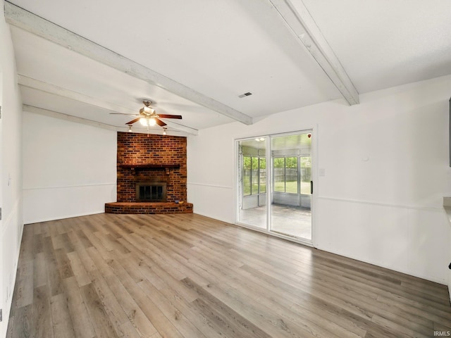 5200 N Leslie Dr, Muncie, IN 47304 - unfurnished living room with beamed ceiling, wood finished floors, ceiling fan, and a fireplace