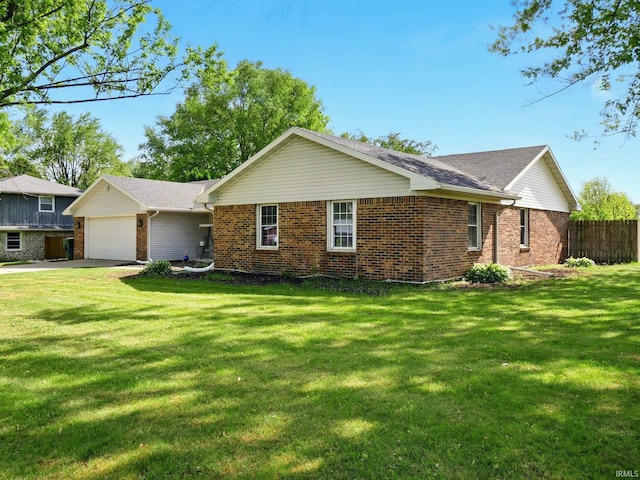 5200 N Leslie Dr, Muncie, IN 47304 - view of side of property featuring brick siding, a garage, and concrete driveway