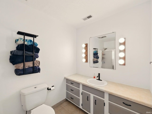 5200 N Leslie Dr, Muncie, IN 47304 - bathroom featuring vanity, tile patterned floors, toilet, and a shower