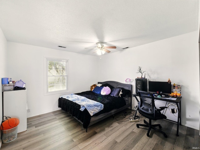 5200 N Leslie Dr, Muncie, IN 47304 - bedroom with wood finished floors, a ceiling fan, and a textured ceiling