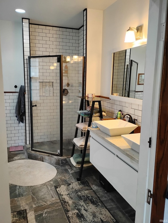 3417 Parkway S Dr, Indianapolis, IN 46201 - bathroom featuring vanity, a shower stall, and backsplash